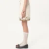 Bermuda en toile de coton avec broderies florales et bordures jacquard Bermuda en toile de coton avec broderies florales et bordures jacquard