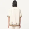 Chemise en toile de coton avec broderies florales Chemise en toile de coton avec broderies florales