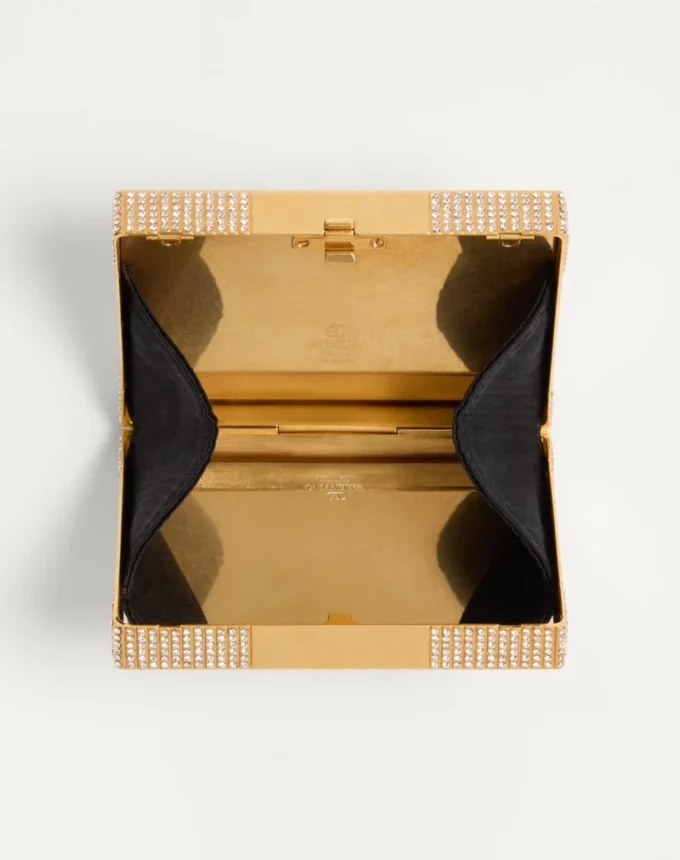 Minaudière Minaumorphe Valentino Garavani en métal avec cristaux Swarovski® et étui en satin Minaudière Minaumorphe Valentino Garavani en métal avec cristaux Swarovski® et étui en satin