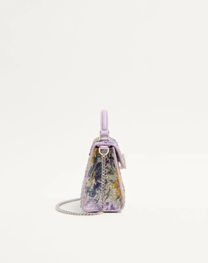 Mini sac à main Valentino Garavani Vsling avec motif Flowerism en strass et logo bijou Mini sac à main Valentino Garavani Vsling avec motif Flowerism en strass et logo bijou