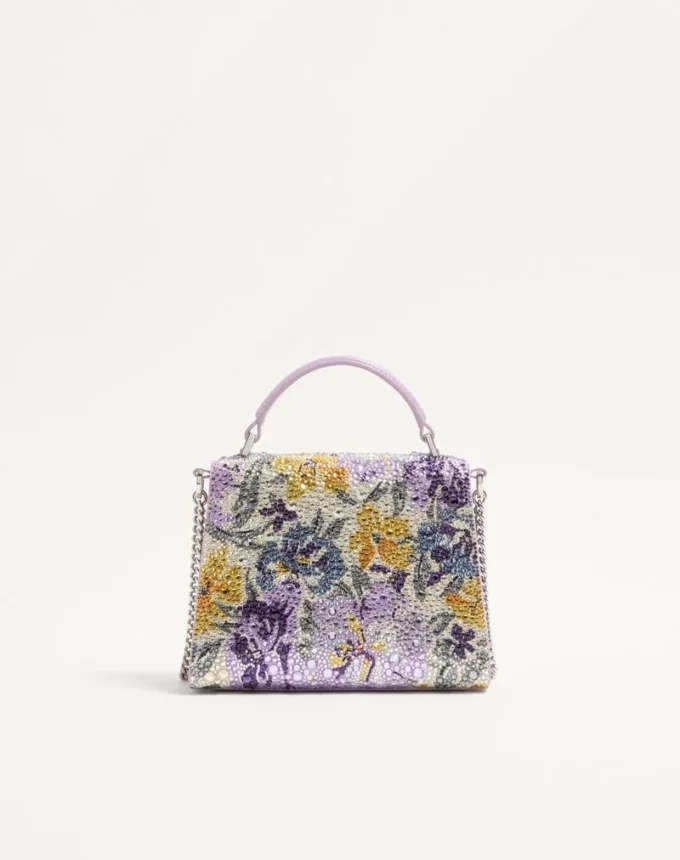 Mini sac à main Valentino Garavani Vsling avec motif Flowerism en strass et logo bijou Mini sac à main Valentino Garavani Vsling avec motif Flowerism en strass et logo bijou