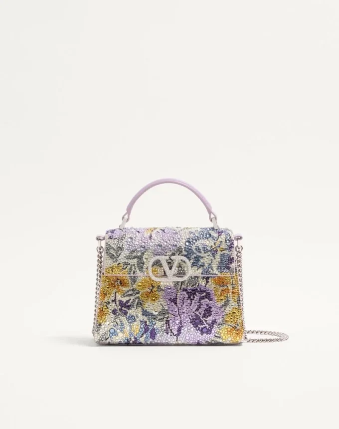 Mini sac à main Valentino Garavani Vsling avec motif Flowerism en strass et logo bijou Mini sac à main Valentino Garavani Vsling avec motif Flowerism en strass et logo bijou