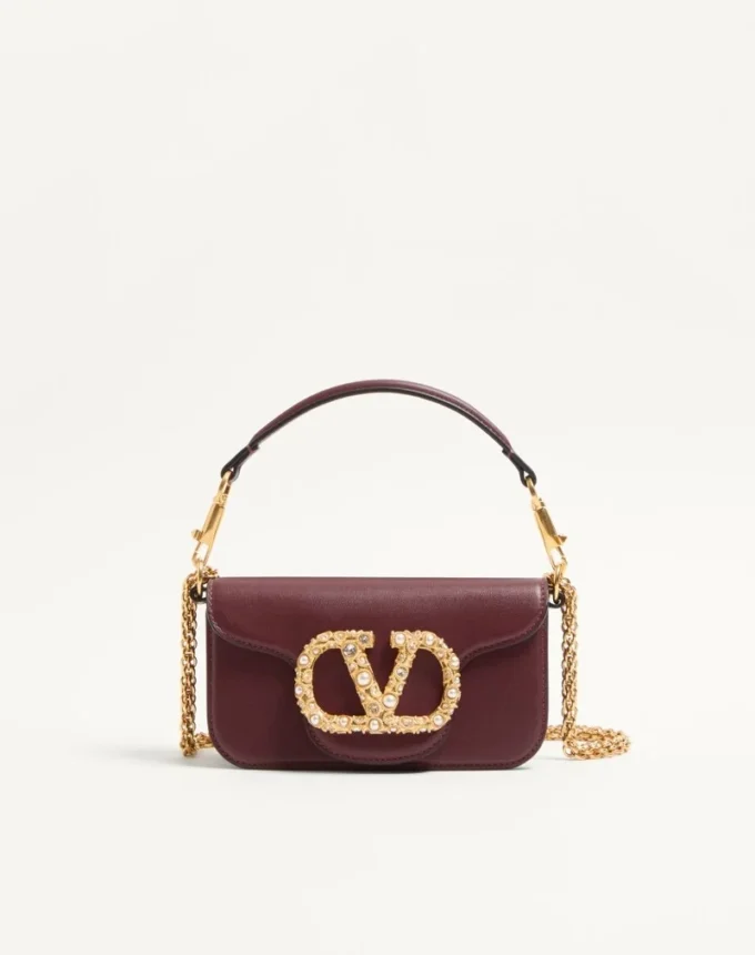 Petit sac à bandoulière Valentino Garavani Locò en cuir de veau avec logo bijou Petit sac à bandoulière Valentino Garavani Locò en cuir de veau avec logo bijou