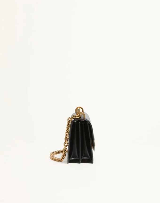Petit sac à bandoulière Valentino Garavani Vain en cuir de veau brillant Petit sac à bandoulière Valentino Garavani Vain en cuir de veau brillant