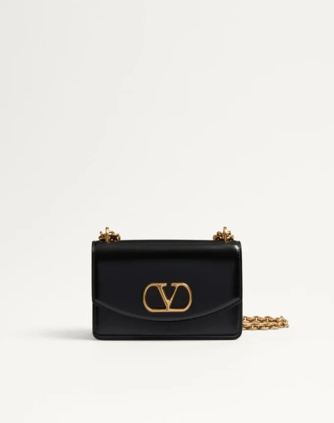 Petit sac à bandoulière Valentino Garavani Vain en cuir de veau brillant Petit sac à bandoulière Valentino Garavani Vain en cuir de veau brillant
