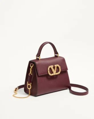 Petit sac à main Valentino Garavani Vsling en cuir de veau grainé avec logo bijou