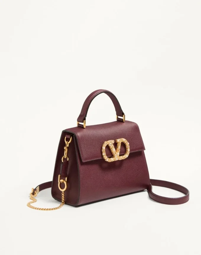 Petit sac à main Valentino Garavani Vsling en cuir de veau grainé avec logo bijou Petit sac à main Valentino Garavani Vsling en cuir de veau grainé avec logo bijou