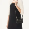 Pochette Rockstud en cuir de veau grainé