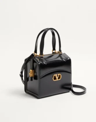 Sac bowling Valentino Garavani Vain-Case en cuir de veau brillant