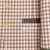 Veste en coton à simple boutonnage avec motif à carreaux et bords imprimés Veste en coton à simple boutonnage avec motif à carreaux et bords imprimés