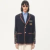 Veste en lin à simple boutonnage avec broderies et empiècements en perles Veste en lin à simple boutonnage avec broderies et empiècements en perles
