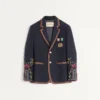 Veste en lin à simple boutonnage avec broderies et empiècements en perles Veste en lin à simple boutonnage avec broderies et empiècements en perles